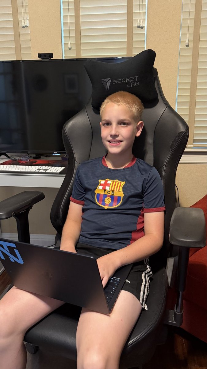 Grayson Smith sitting with a laptop and talking about why technology matters to kids.
